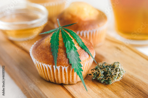 Delicious homemade muffin with CBD cannabis and leaf garnish. Medicinal Edibles. Treatment of medical marijuana for use in food. Canada legalization. Rasta muffin