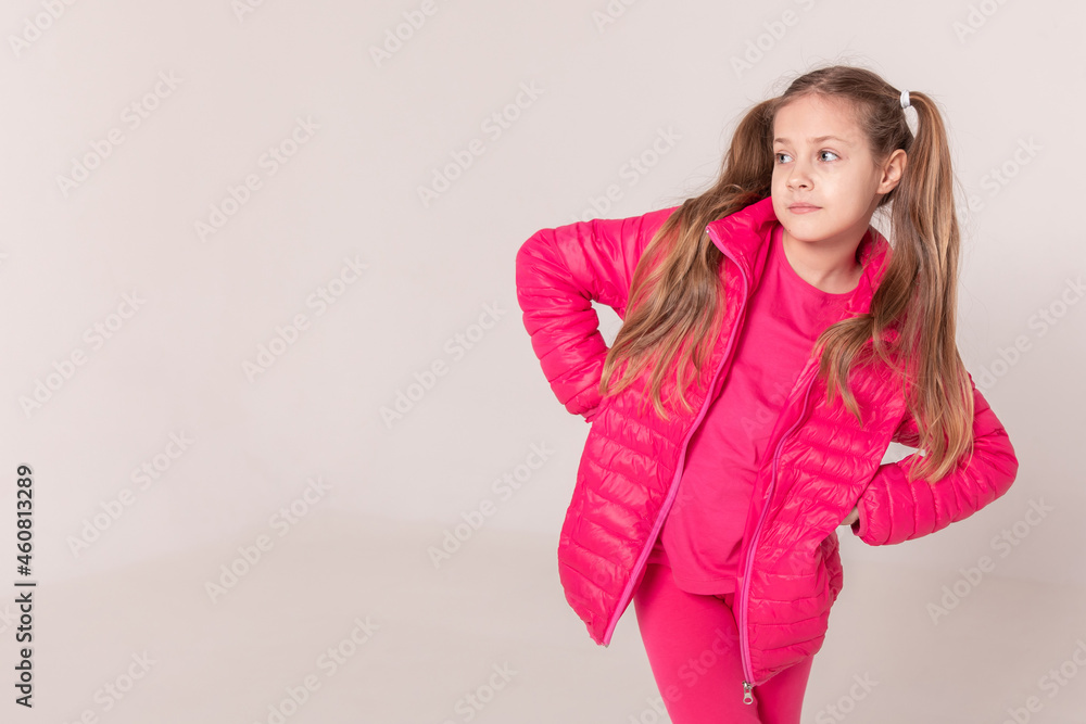 girl with tails on a white background. baby in a pink jacket girl with tails on a white background. baby in a pink jacket
