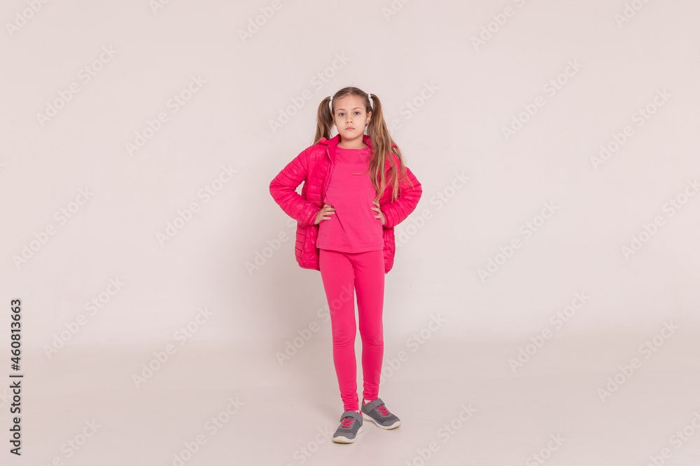 girl with tails on a white background. baby in a pink jacket girl with tails on a white background. baby in a pink jacket