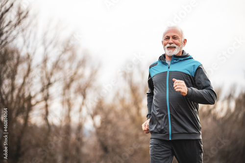 Active senior man is jogging. Healthy retirement lifestyle.