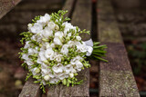 White freesia bridal bouquet on dark background. close up. Wedding bouquet.