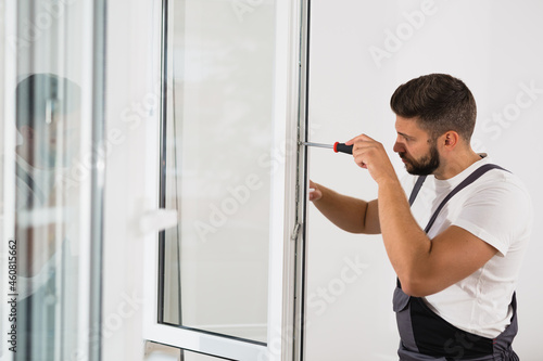 worker fixing pvc windows indoor