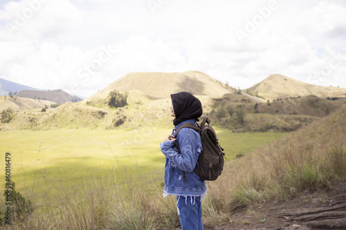 Young asian backpacker girl is happy and enjoy traveling in Wurung Crater (Kawah Wurung).