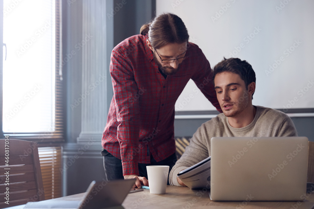 Business men working together in sunny office Business men working together in sunny office