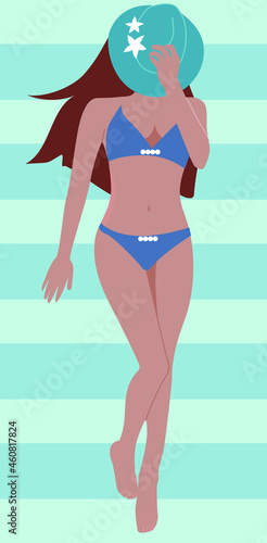 Beautiful woman sunbathes at the beach