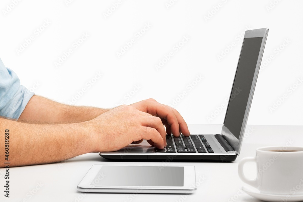 Male hands writes on laptop. Entrepreneur man sit at desk work on modern notebook, Male hands writes on laptop. Entrepreneur man sit at desk work on modern notebook,