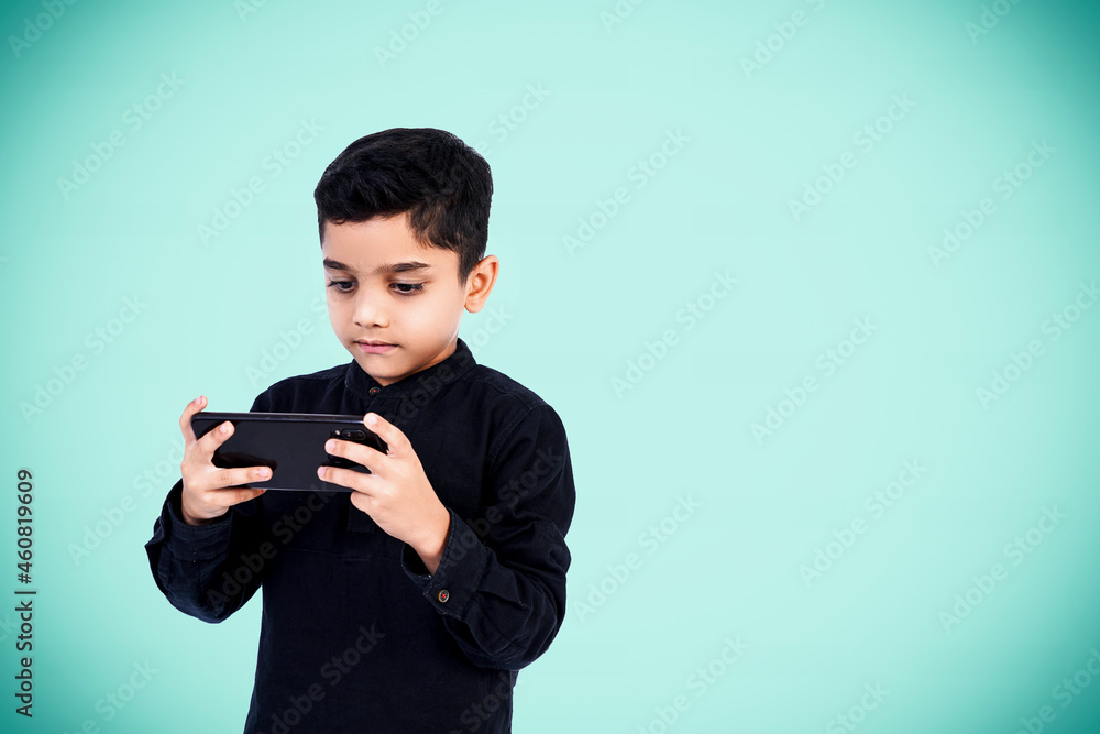 Indian little boy with smart phone Indian little boy with smart phone
