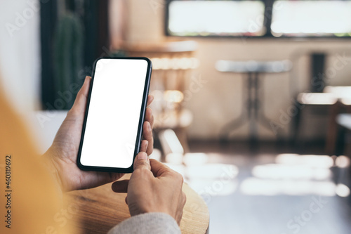 cell phone blank white screen mockup.woman hand holding texting using mobile on desk at office.background empty space for advertise.work people contact marketing business,technology © panitan