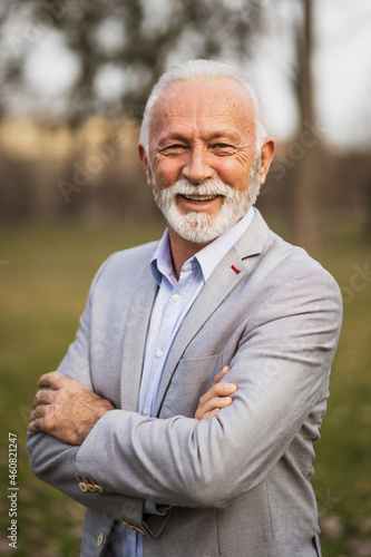 Outdoor portrait of cheerful senior businessman.