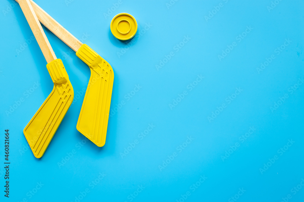 Two hockey sticks and puck. Competitive sports equipment Two hockey sticks and puck. Competitive sports equipment