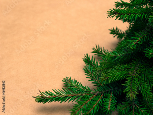 Christmas composition. Christmas decor  spruce branches on craft  fir branches  winter craft paper background. Flat lay  top view  copy space. new year holidays