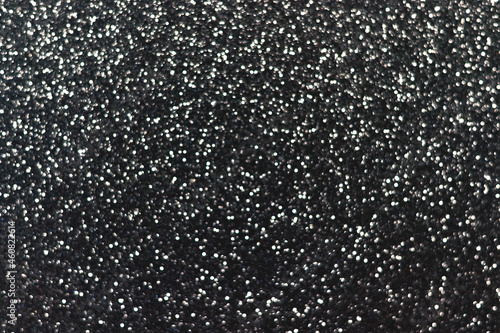 Silver black sparkling glitter bokeh background, christmas abstract defocused texture