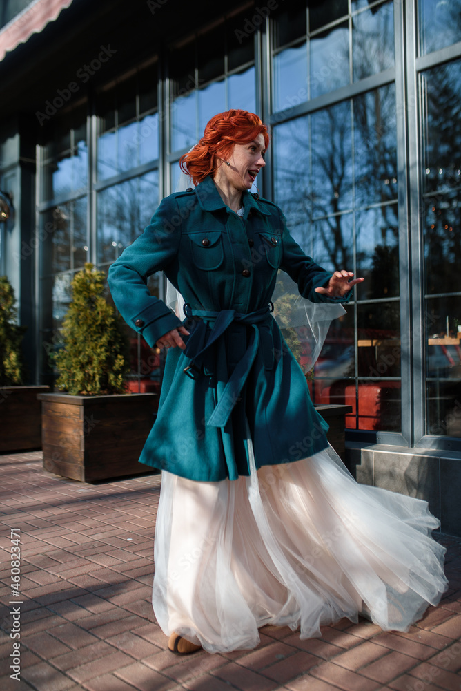 wedding day, bride is happy and in love, crazy about love and wedding. the bride is dancing in a wedding dress on the street
