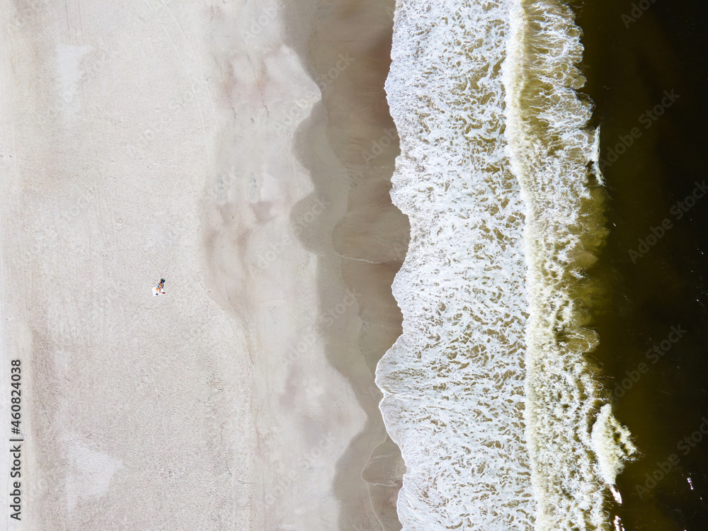 lonely woman sunbathes on the sand by the ocean. lonely woman sunbathes on the sand by the ocean.
