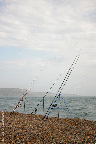 Fishing rods on a pebble beach. 