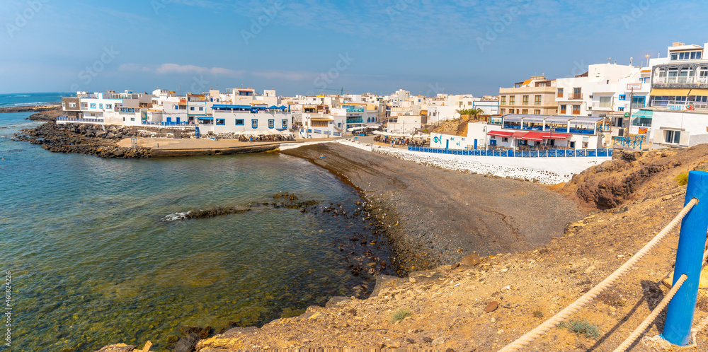 Panoramic view from above of the black beach of the tourist town of El Cotillo in the north of the island of Fuerteventura, Canary Islands. Spain