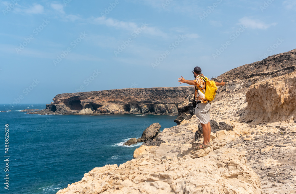 A young tourist on the trail heading to the caves of Ajuy, Pajara, west coast of the island of Fuerteventura, Canary Islands. Spain