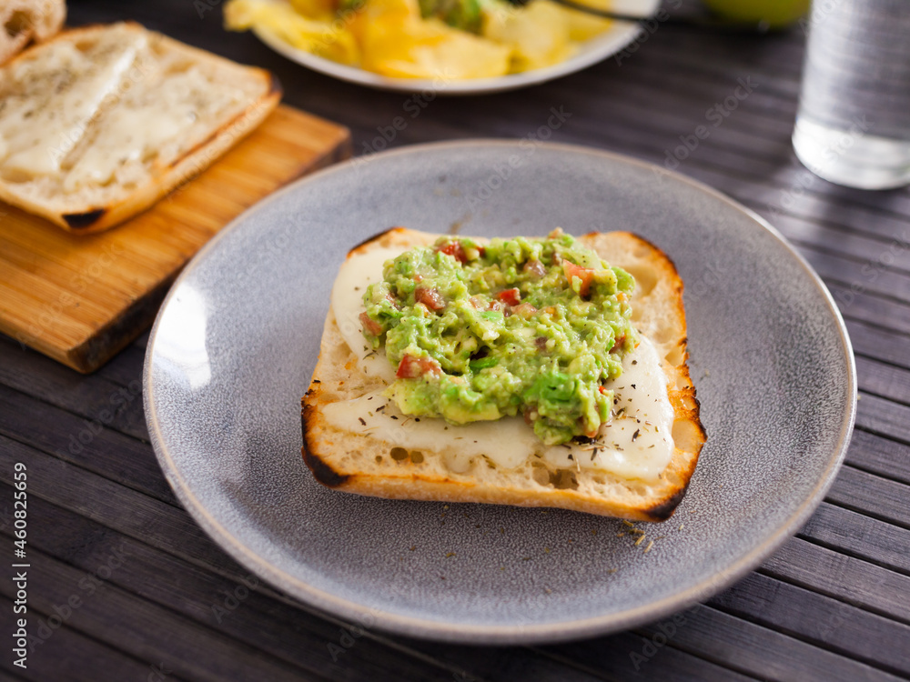 morning toast with melted cheese and guacamol