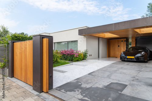 Luxury car parked near entrance of residential house photo