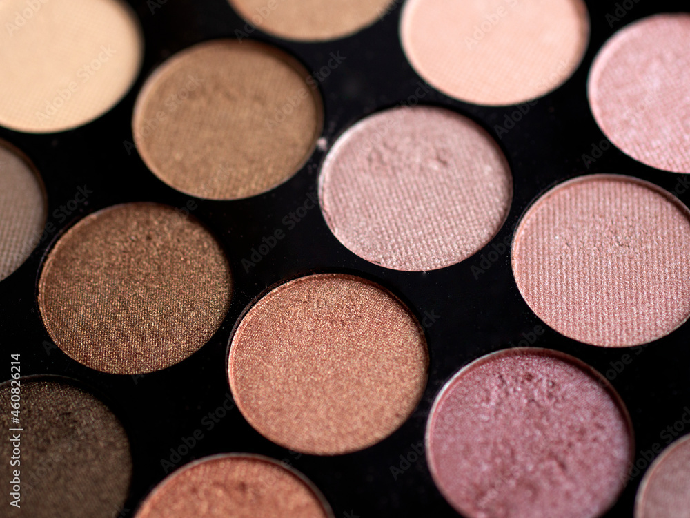 Fototapeta premium Make-up eye shadow palette close up. Professional multicolor eyeshadow palette. Makeup. Professional multicolor eyeshadow make up palette background. Colorful bright eye shadows set backdrop