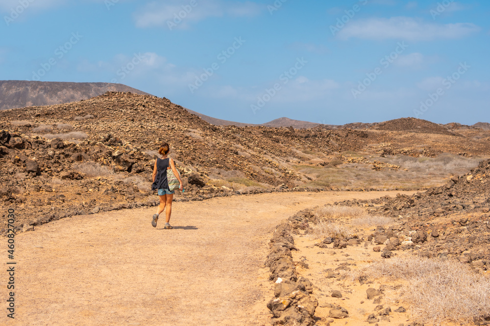 A young tourist visiting the Isla de Lobos, off the north coast of the island of Fuerteventura, Canary Islands. Spain