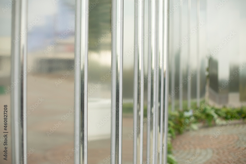 Fototapeta premium Mirror wall in the park. Architectural element to decorate the city. Reflective surface.