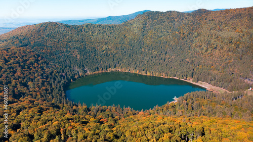 Aerial  drone panorama view of the fall season over Saint Anne (Sfanta Ana) volcanic lake. Forest and water. Harghita, Romania, in autumn photo