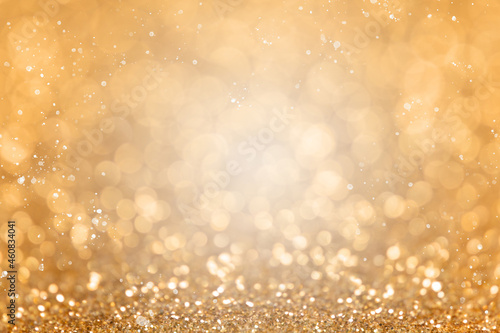 Out of focus golden bokeh. Festive background for christmas, new year, wedding. Snow