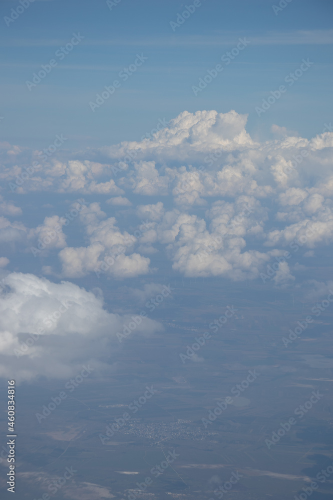 View from the plane. Natural landscape and cumulus clouds View from the plane. Natural landscape and cumulus clouds