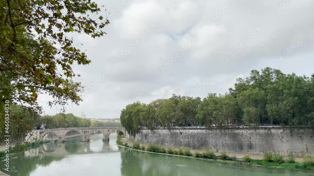 Tranquil scene of Rome in the afternoon with calm water in the Tiber river, the lush foliage and St Peter's Basilica in the horizon. Footage made in September, 2021 in Rome, Italy. Tranquil scene of Rome in the afternoon with calm water in the Tiber river, the lush foliage and St Peter's Basilica in the horizon. Footage made in September, 2021 in Rome, Italy.