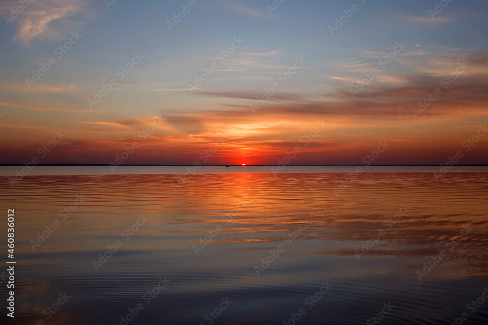 Amazing sunset at sea, golden hours, gratitude for the day. Beautiful background. Orange sundown. Focus on horizon