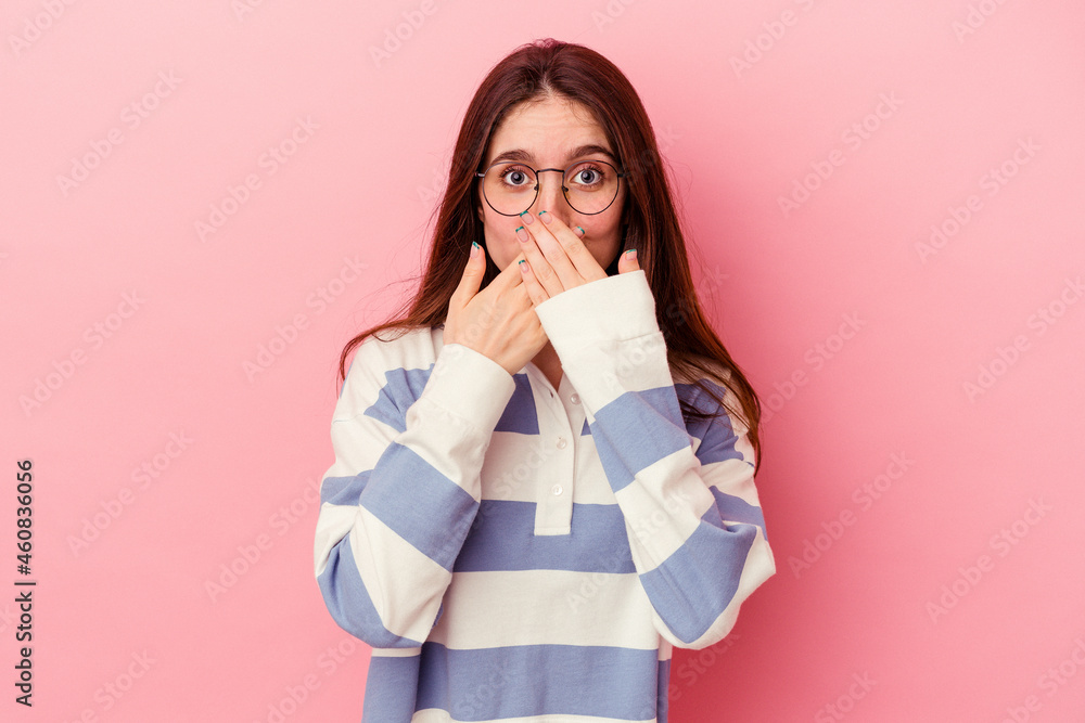 Young caucasian woman isolated on pink background shocked covering mouth with hands. Young caucasian woman isolated on pink background shocked covering mouth with hands.