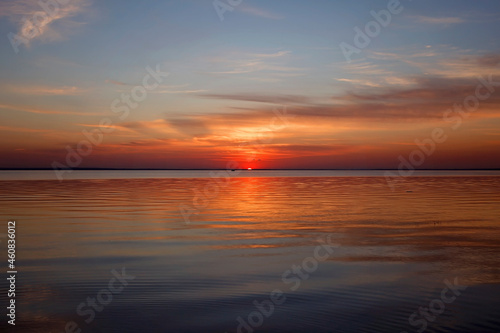 Amazing sunset at sea  golden hours  gratitude for the day. Beautiful background. Orange sundown. Focus on horizon