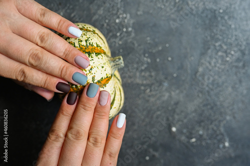 autumn nails design. trendy manicure. Top view. Place for text. Autumn leaves and pumpkins photo