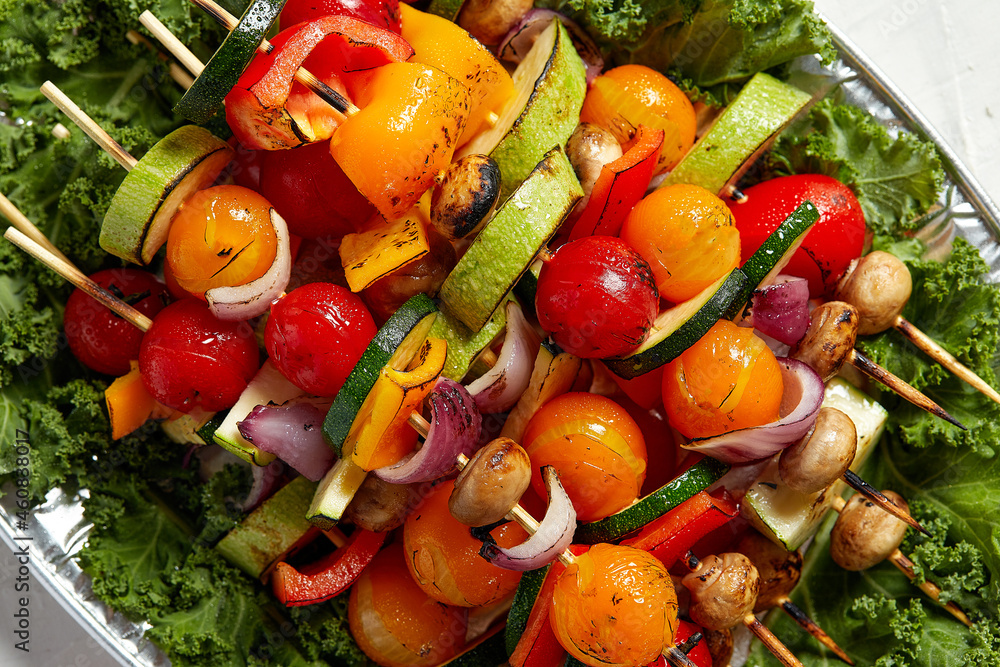 vegetarian skewers with dry herbs on wooden skewers of zucchini tomato onion mushrooms on a plate vegetarian skewers with dry herbs on wooden skewers of zucchini tomato onion mushrooms on a plate
