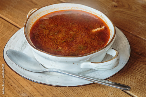 Traditional Georgian soup Kharcho with meat and rice on wooden background.