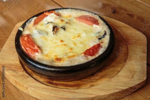 Eggplants  in a frying pan, baked with vegetables and cheese. Dish of Mediterranean cuisine. Restaurant shooting.