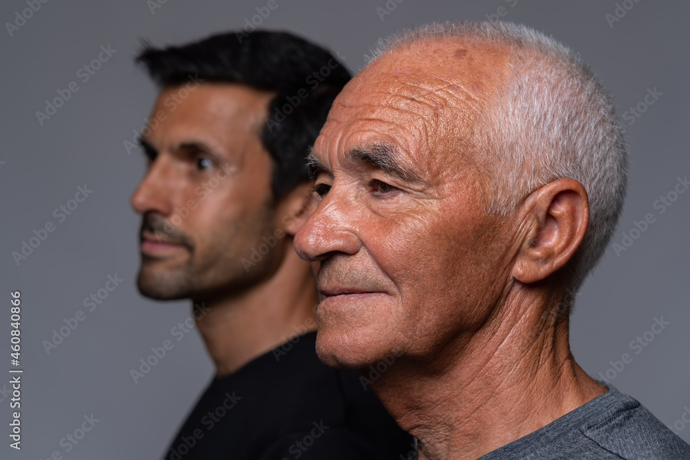 Fototapeta premium Descendants of the older generation of Europeans, concept in portrait. The old man and his son close up.
