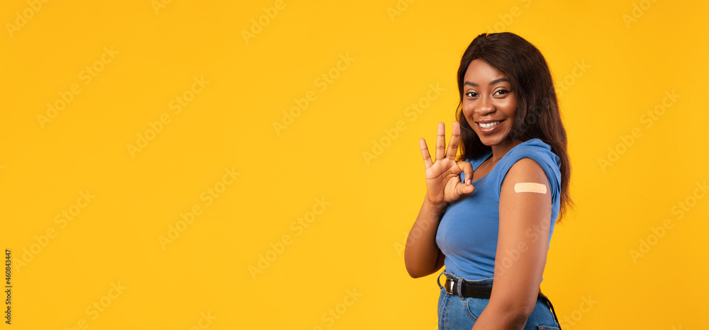 Vaccinated African Woman Gesturing Okay Approving Antiviral Vaccine, Yellow Background Vaccinated African Woman Gesturing Okay Approving Antiviral Vaccine, Yellow Background