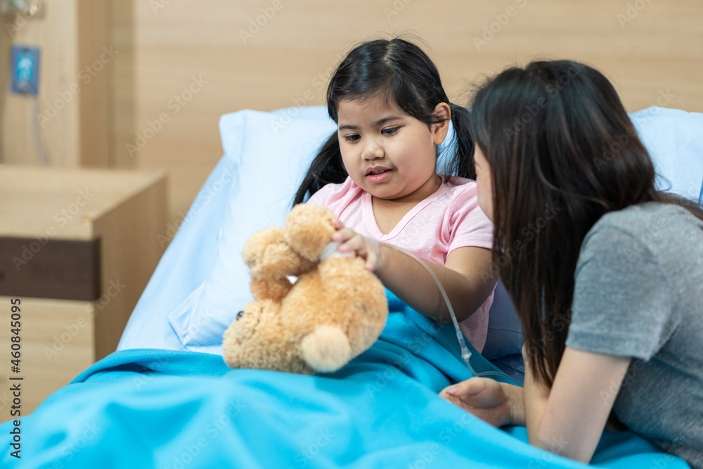 asian girl with a broken arm wearing a cast on the hospital bed with her mother asian girl with a broken arm wearing a cast on the hospital bed with her mother