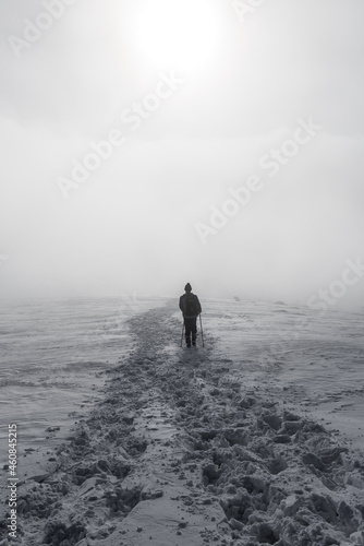 tourist in winter goes into a thick fog