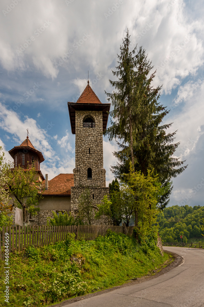 Stone and wood orthodox church on a hill in the Carpathian Mountains in Transylvania in Romania
