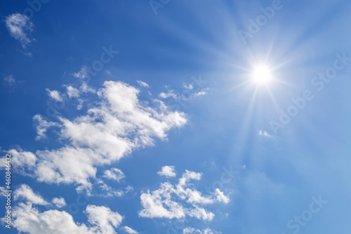 Bright sun with beams on sky with light fluffy clouds soft focus. Heavenly clouds background in summer day. Concept of freedom  relaxation  ecology. Copy space. Empty space.