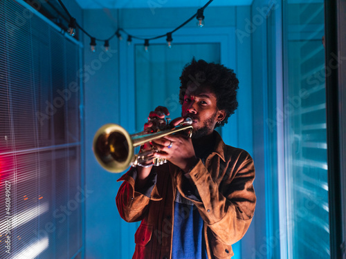 Young trumpeter performs at home