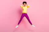 Full size photo of impressed millennial brunette lady jump wear shirt jeans shoes isolated on pink background