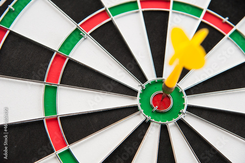 Yellow dart in the center on color target and board