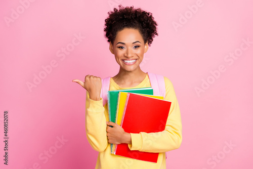 Photo of nice millennial brunette lady hold books point wear yellow shirt isolated on pink color background