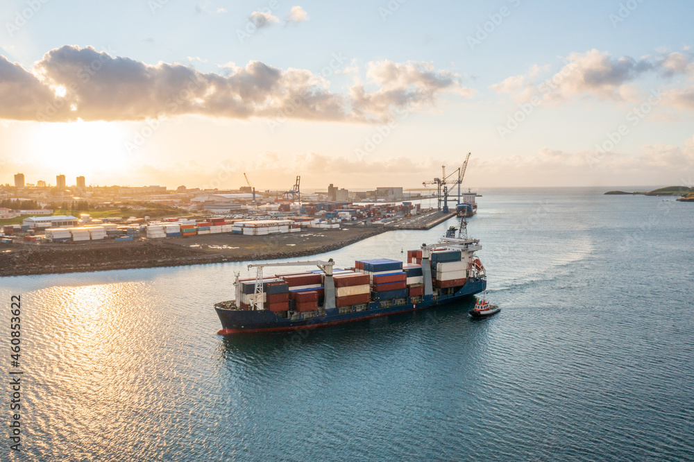 A pilot boat is guiding a cargo ship to dock. A pilot boat is guiding a cargo ship to dock.