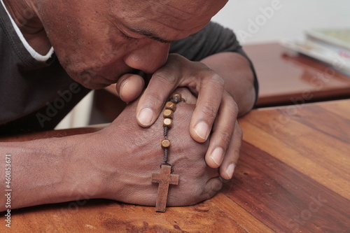 praying with the holy cross in church stock photo