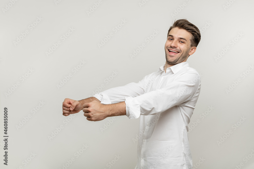 Portrait of nice attractive confident cheerful cheery glad bearded guy wearing classic white shirt holding in hands driving invisible car isolated over white background Portrait of nice attractive confident cheerful cheery glad bearded guy wearing classic white shirt holding in hands driving invisible car isolated over white background